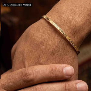 7 of 10: Close-up of a slim hammered Nu Gold brass cuff bracelet worn on a wrist, showing its narrow 3.5mm width and lightly textured surface that reflects warm golden tones. The open cuff design sits comfortably above the wrist bone, styled on skin with natural texture visible, highlighting its minimalist, handcrafted look in a lifestyle setting.  AI Generated Model.