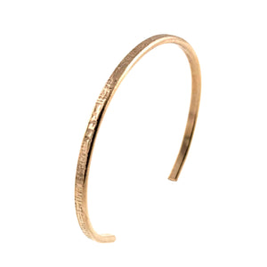 9 of 10: Angled view of a handcrafted 3.5mm linen bronze cuff bracelet with a slim, open design. The outer surface features a subtle hand-hammered linen texture, while the inner side is smooth. The warm golden bronze tone is highlighted against a clean white background, showcasing its minimalist and lightweight style.