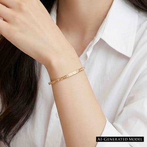 2 of 10: Close-up of a woman’s wrist wearing a slim 3.5mm linen bronze cuff bracelet with a subtle hand-hammered texture. The warm golden tone pairs elegantly with a crisp white blouse, creating a clean and refined look with soft, natural lighting.  AI Generated Model.