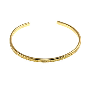 3 of 10: Front view of the handmade 3.5mm Linen Nu Gold Brass Cuff Bracelet. The slim open cuff is crafted from solid raw Nu Gold Brass with a polished finish and hand applied linen texture, offering a clean minimalist style.