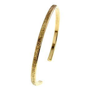 5 of 10: Side profile of the handmade 3.5mm Linen Nu Gold Brass Cuff Bracelet. The narrow solid Nu Gold Brass cuff features a polished interior and hand applied linen texture on the outer edge, showing its lightweight handcrafted construction.