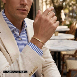 8 of 10: AI generated male model wearing the handmade 3.5mm Linen Nu Gold Brass Cuff Bracelet with a cream blazer and blue striped dress shirt. The narrow polished brass cuff features a hand applied linen texture and offers a refined, modern accessory for everyday or business wear.