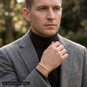 4 of 10: AI generated model wearing the handmade 3.5mm Linen Nu Gold Brass Cuff Bracelet on the wrist with a gray herringbone blazer and dark brown turtleneck. The slim polished brass cuff features a hand applied linen texture and warm gold tone, styled as modern minimalist jewelry for men.