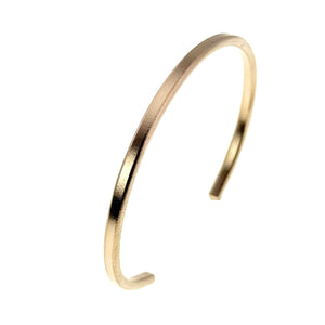 3 of 9: Angled close up of a 3.5mm matte bronze cuff bracelet against a white background. The handcrafted bronze cuff features a brushed satin texture, slim minimalist shape, and warm metallic glow that complements both casual and dressy fashion styles.
