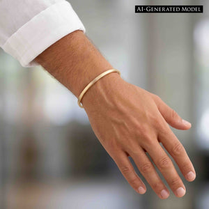 8 of 9: Man wearing a narrow matte bronze cuff bracelet with a white shirt sleeve. The handcrafted solid bronze cuff has a clean minimalist design with a brushed matte finish and warm golden bronze color, creating a modern unisex jewelry look for everyday style.  AI Generated Model.
