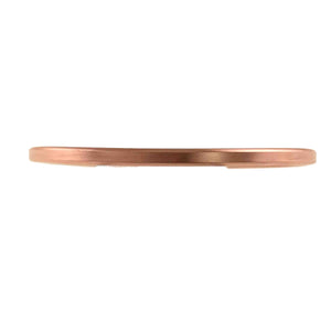 7 of 10: Side view of the 3.5mm matte copper cuff bracelet, showing its slim profile, smooth brushed surface, rounded edge, and solid copper construction.