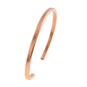 9 of 10: Angled view of the slim matte copper cuff bracelet, showing the open cuff shape, rounded ends, warm copper color, and softly brushed handmade finish.