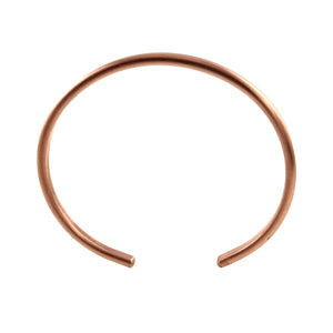 5 of 10: Matte copper cuff bracelet shown from above, highlighting the slim open shape, rounded ends, warm raw copper tone, and clean brushed finish on a white background.