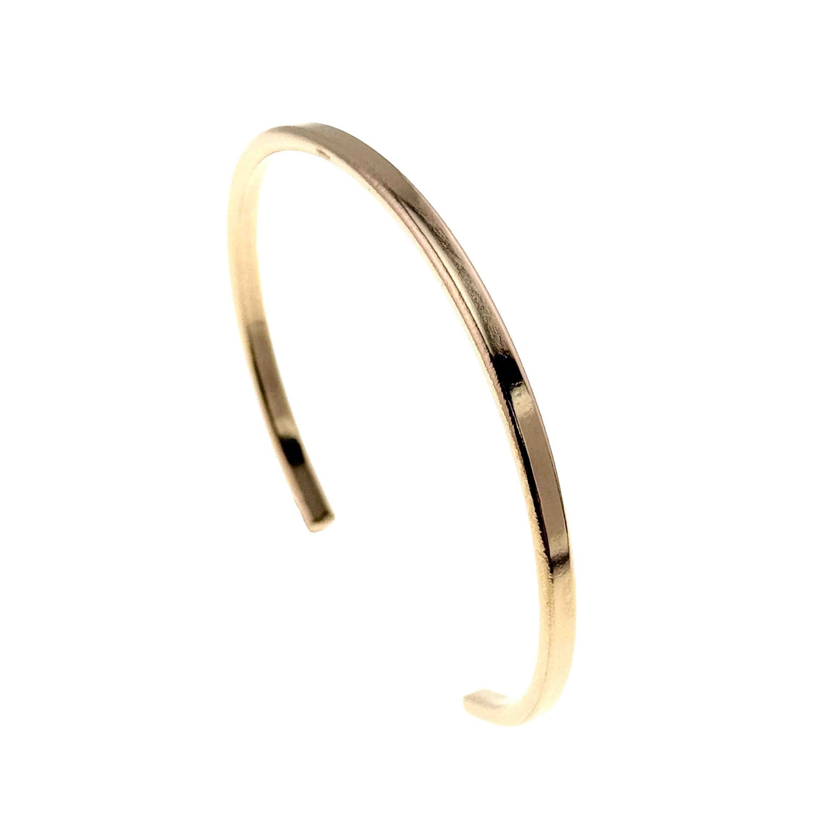 Opposite angled side product view of a slim polished bronze cuff bracelet standing upright on a white background. The image shows the open ends, rounded shape, narrow width, smooth edges, and mirror bright bronze surface from the reverse angle.