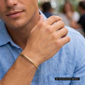 6 of 10: A man in a light blue button front shirt rests one hand near his chin while wearing a slim polished bronze cuff bracelet. The warm golden band stands out against his skin and blue shirt, with a softly blurred outdoor background. A label reads “AI GENERATED MODEL.”