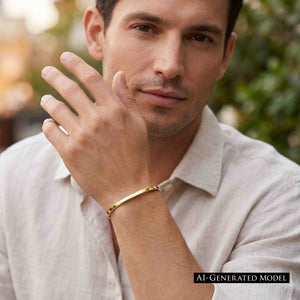 4 of 11: Man wearing a narrow polished golden brass cuff bracelet with a light casual shirt outdoors. He holds one hand near his face, drawing attention to the smooth reflective bracelet around his wrist. A black label reads AI generated model.