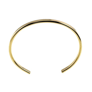 3 of 11: Top view of a slim polished Nu Gold brass cuff bracelet centered on a white background. The open ends face downward, while the smooth golden band forms a rounded oval with a bright mirror finish.