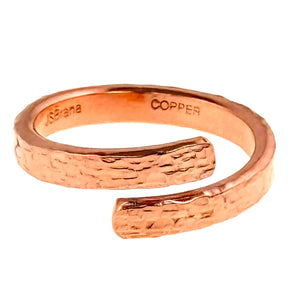 3 of 9: Front close view of the 3.5mm texturized copper bypass ring on a white background. The polished solid copper band curves into two rounded open ends, with the John S. Brana maker mark and COPPER stamp visible inside.