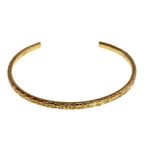 5 of 9: Front angled product view of a 3.5mm texturized Nu Gold brass cuff bracelet on a white background. The slim open bracelet has a warm golden color, polished upper edge, textured outer face, gently curved shape, and smooth squared ends.