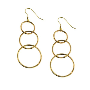 1 of 8: Pair of 3 Tiered Hammered Nu Gold Brass Chandelier Earrings displayed on a white background, featuring three graduated open circles with hand hammered texture, polished golden shine, and 14K gold plated brass French ear wires.
