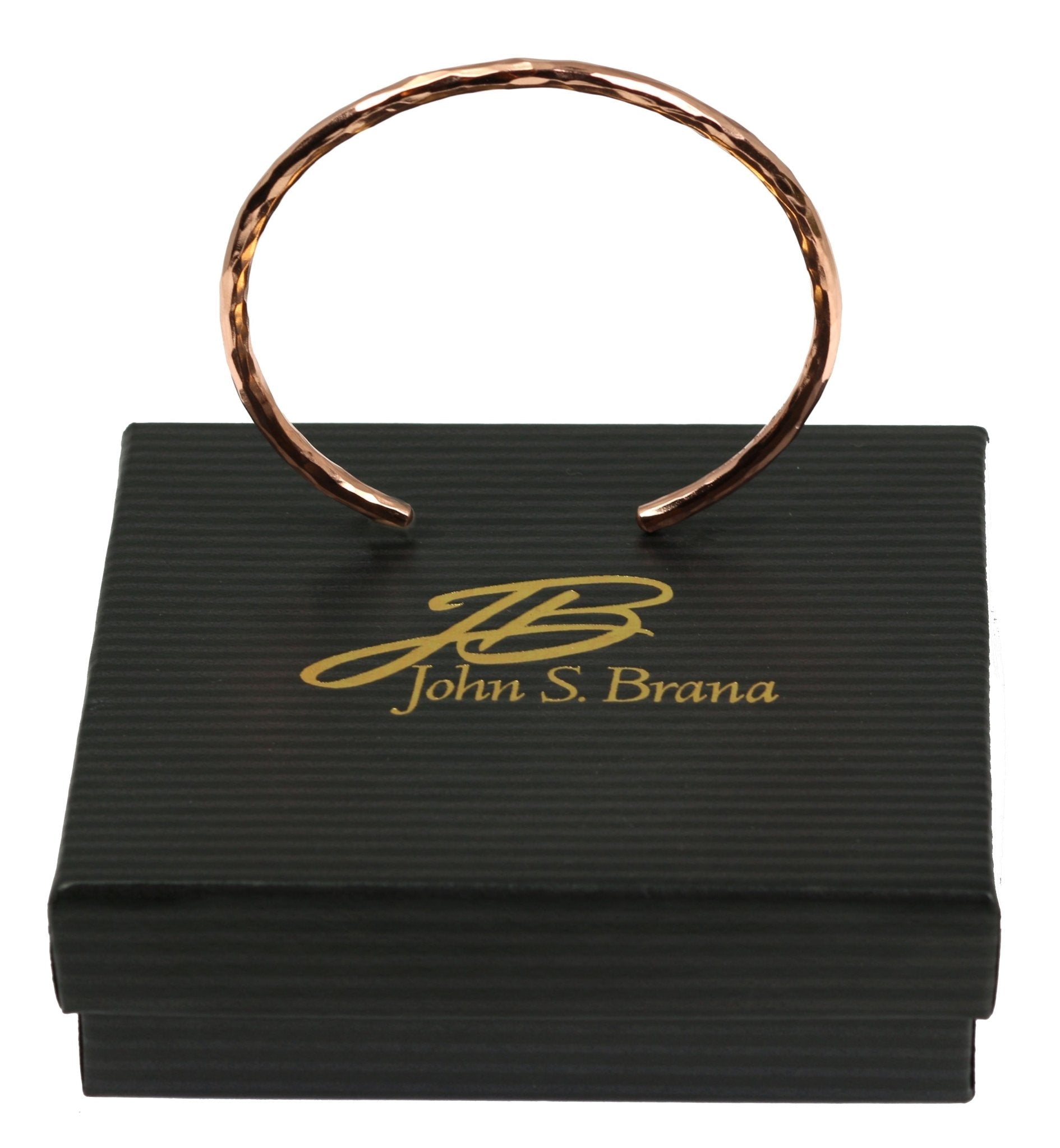 3mm Wide Hammered Copper Cuff Bracelet on top of a Black Gift Box with Gold Logo