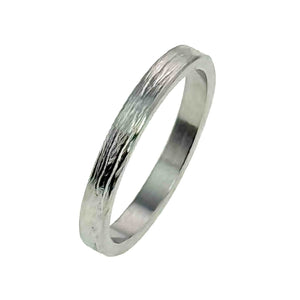 5 of 10: A close-up image of a slim, handcrafted stainless steel ring with a flat band and a bark-textured surface. The ring features a polished finish that highlights the natural grooves of the bark pattern, giving it a sleek yet organic look.