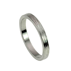 1 of 10: A slim, handcrafted stainless steel ring with a flat band design, featuring a bark-like textured surface and a polished finish. The ring has a natural, organic look and a clean, modern shape, suitable for both men and women.