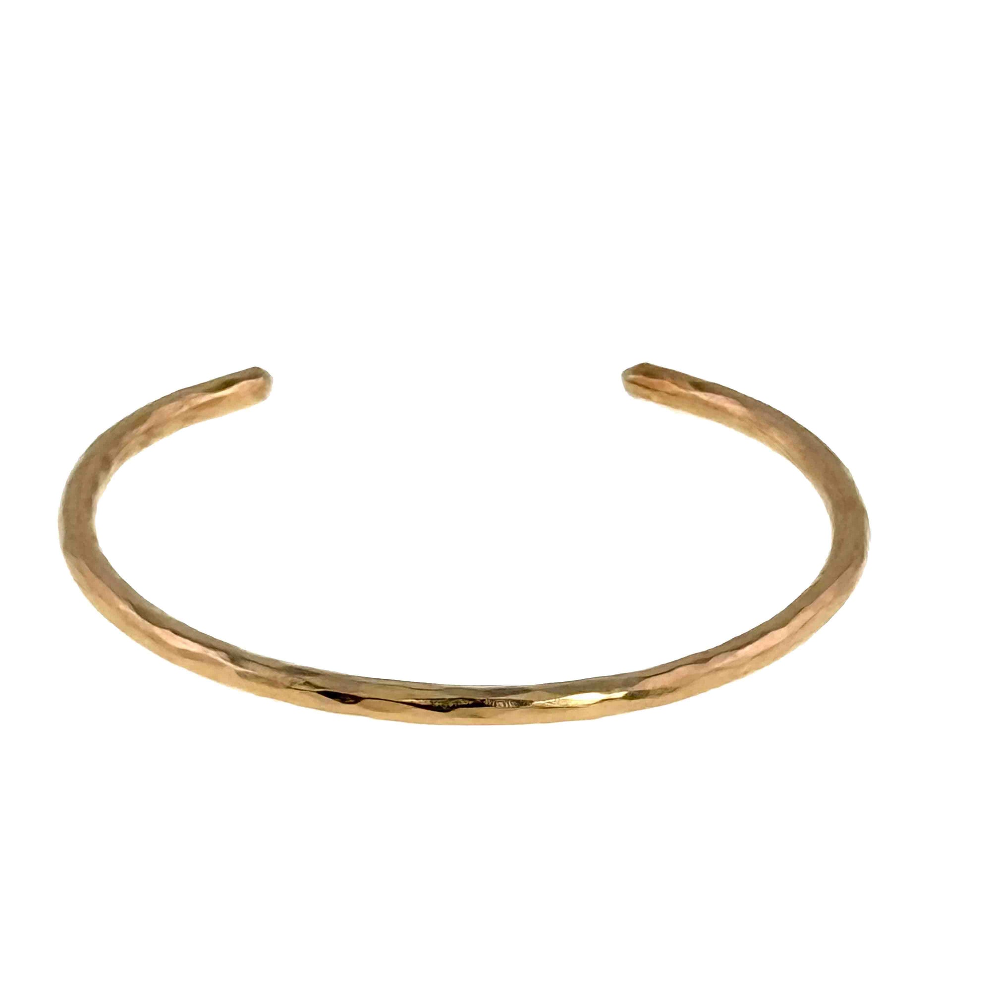 Detail of 3mm Wide Hammered Solid Bronze Cuff Bracelet Laying Flat on a White Background