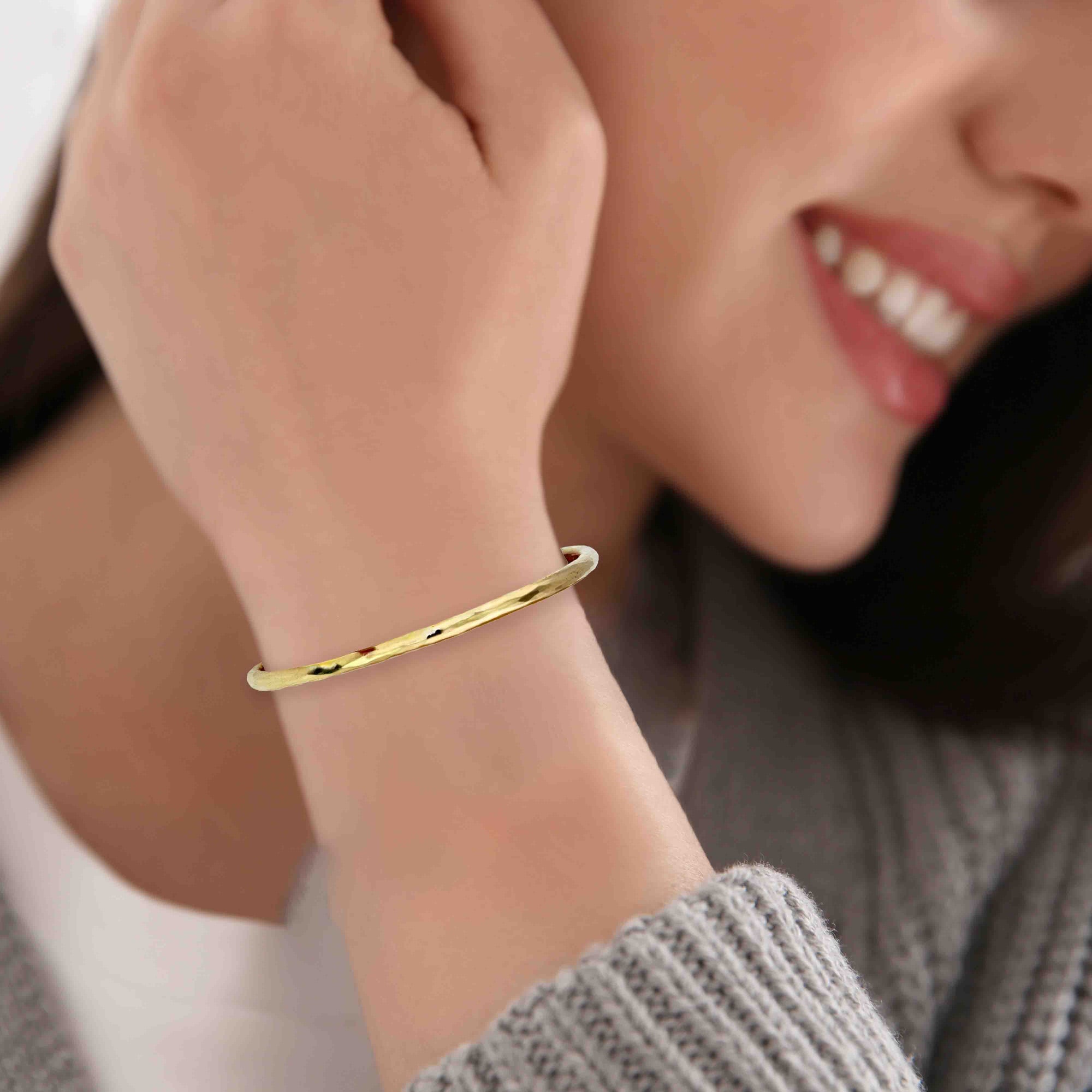 3mm Hammered Solid Nu Gold Brass Cuff Bracelet on a woman's wrist with a blurred background