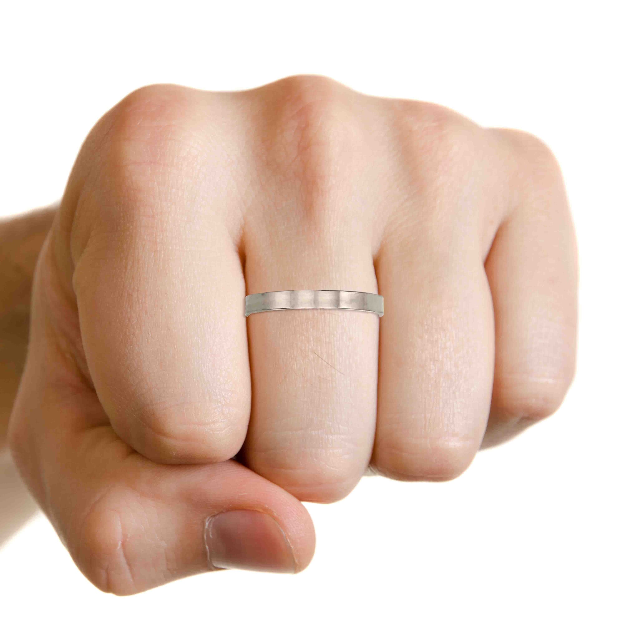 Hand wearing a 3mm Matte Stainless Steel Flat Ring on a white background