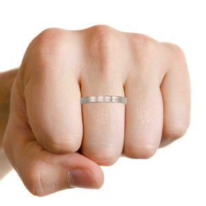 2 of 9: Hand wearing a 3mm Matte Stainless Steel Flat Ring on a white background