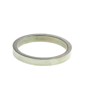 5 of 9: Angled view of a slim stainless steel flat band ring on a white background. The ring features a narrow width, straight sides, and flat inner and outer surfaces with a smooth polished silver finish. Its clean minimalist shape and unisex style make it a versatile choice for everyday wear, stacking, wedding bands, engagement rings, or 11th anniversary gifts.