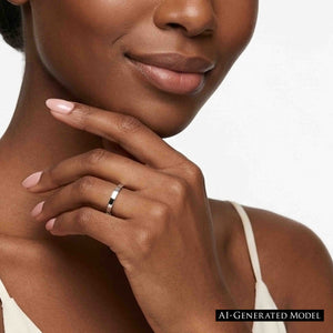 8 of 9: Close up of a woman wearing a slim polished stainless steel flat band ring on her finger, with her hand resting lightly under her chin. The bright silver ring has a narrow width, flat profile, and smooth reflective finish that stands out against her soft pink nails and neutral camisole. Its simple unisex style suits everyday wear, stacking, engagements, weddings, or anniversary gifting.  AI Generated Model.