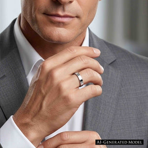 6 of 9: Close up of a man in a light gray suit and white dress shirt wearing a polished stainless steel flat band ring on his finger. His hand is raised near his chin, showing the ring’s slim width, flat profile, and bright mirror finish. The smooth silver tone adds a clean modern touch, making it well suited for everyday wear, weddings, engagements, or anniversary styling.  Ai Generated Model.