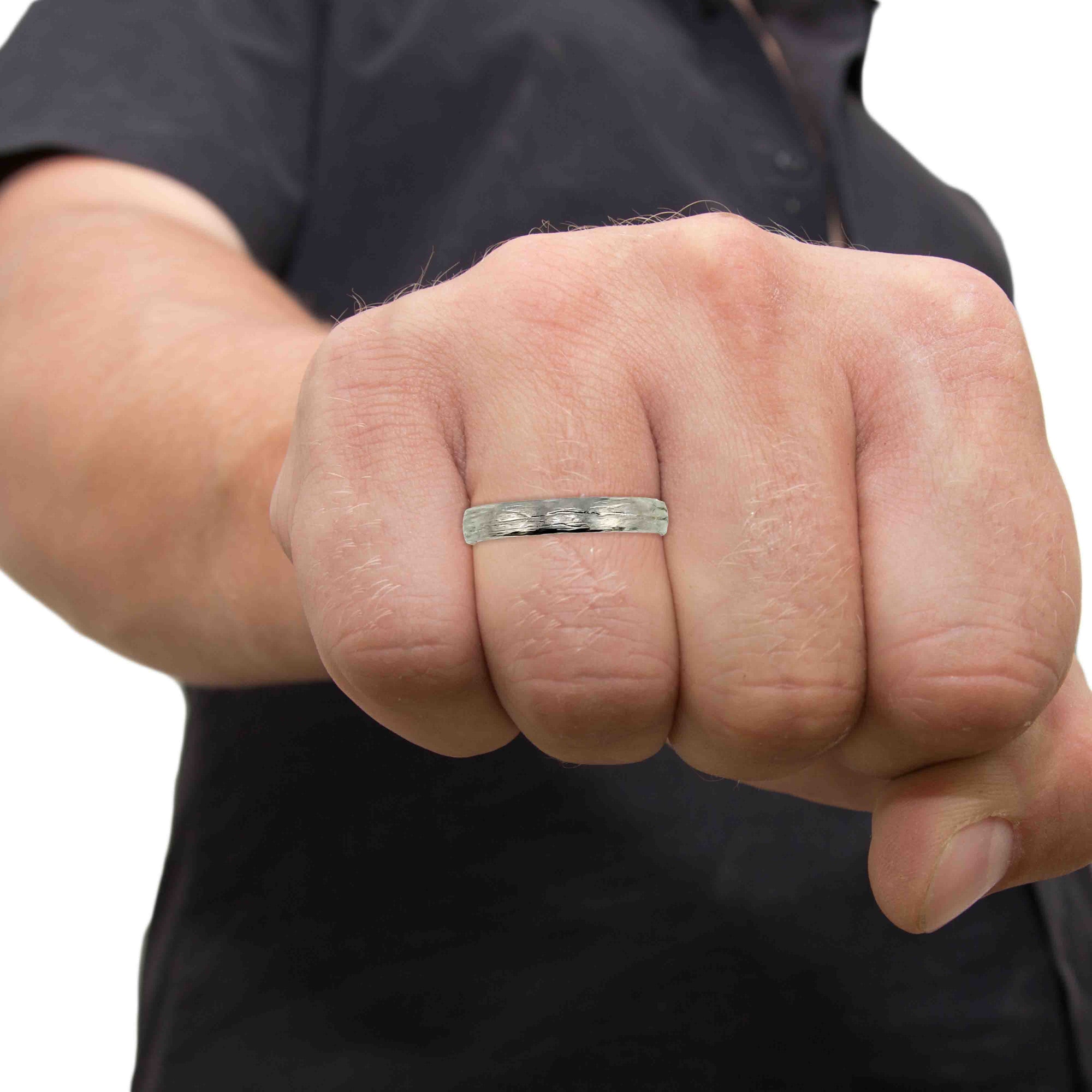 A Man's Hand wearing a 3mm Bark Stainless Steel Comfort Fit Ring with a blurred background