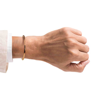 2 of 8: Hand wearing a 3mm Wide Hammered Solid Copper Cuff Bracelet on a white background