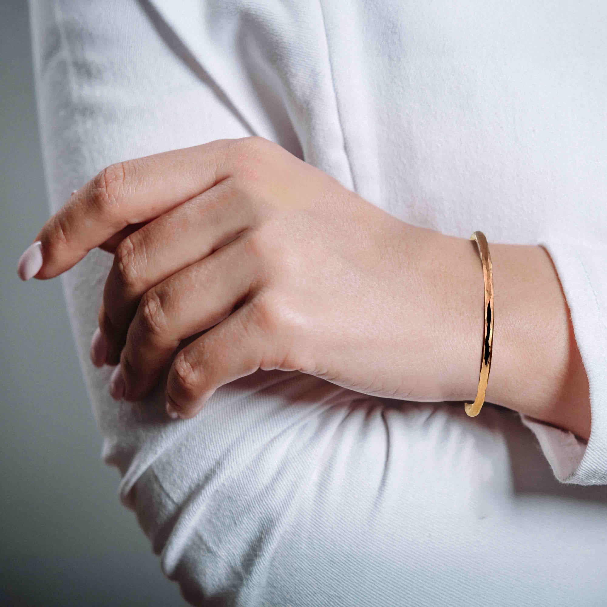 3mm Wide Hammered Solid Copper Cuff Bracelet on a Woman's wrist with a neutral background