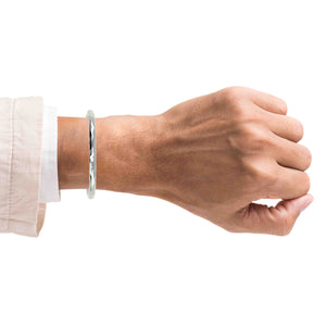 2 of 9: A Man's arm wearing a 4.75mm Hammered Aluminum Cuff Bracelet on a white background