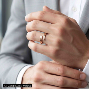 4 of 9: Close up of a hand wearing a slim bronze bypass ring on the ring finger. The open band wraps around with two straight ends that nearly meet, showing a subtle bark texture and warm coppery bronze shine. The ring is styled on a person in a light gray suit and white shirt, giving it a clean, modern, unisex look.  AI Generated Model.