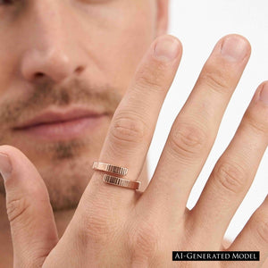 4 of 9: Close view of a man wearing a 4mm chased bronze bypass ring on his finger against a light background. The open wrap design has two parallel textured ends. Part of his face appears softly out of focus behind his hand.  AI Generated Model.