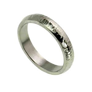 1 of 9: Angled three quarter view of a 4mm chased stainless steel domed ring on a white background. The polished silver band has a rounded outer profile, hand chased texture that catches the light, and a smooth flat interior designed for a comfortable fit.