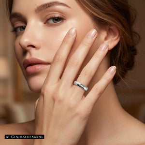 6 of 9: Close portrait of a woman resting her hand against her face while wearing a slim 4mm chased stainless steel domed ring. The polished silver band shows a hand worked texture and bright reflective finish. Warm brown studio lighting creates a soft fashion look. The image includes an AI generated model label.