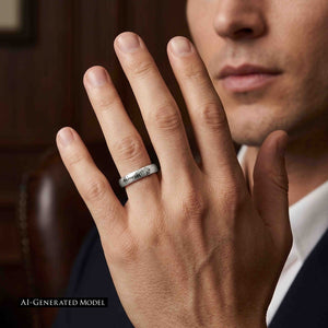 8 of 9: Close portrait of a man in formal clothing holding his hand near his face while wearing a 4mm chased stainless steel domed ring. The bright polished band shows uneven hand worked texture across its surface. A dark brown background adds warmth. The image includes an AI generated model label.