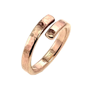 5 of 9: Polished 4mm hammered bronze bypass ring shown upright on a white background. The open overlapping ends and reflective hand worked texture are clearly visible.