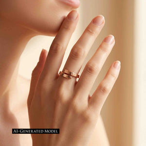 2 of 9: An adult model wears a warm bronze bypass ring on the ring finger while holding a hand near the face. Soft golden light highlights the polished hammered ends. An AI generated model label appears at the lower leftt.