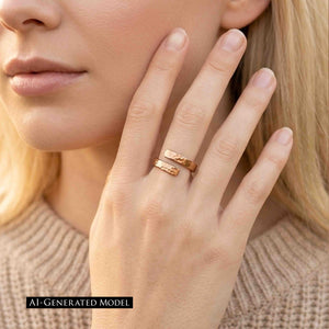 4 of 9: An adult woman's hand wearing a 4mm hammered bronze bypass ring is shown against a warm brown interior. The polished open band reflects the light. An AI generated model label appears at the lower left.