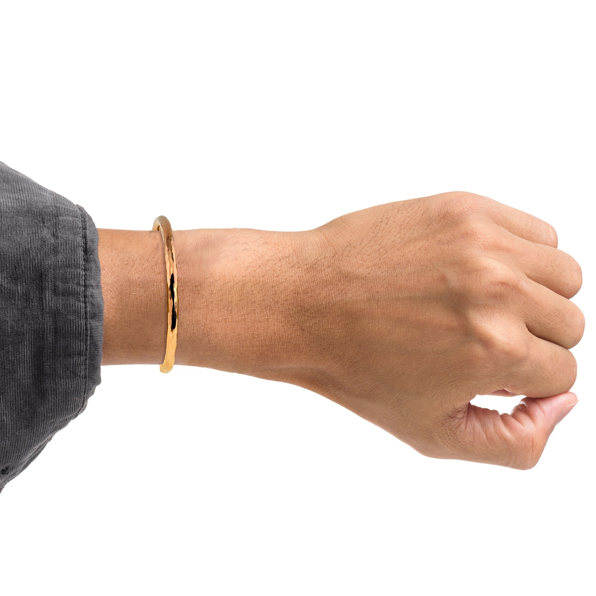 Hand wearing a 4.75 mm Hammered Copper Cuff Bracelet on a white background