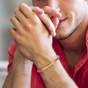 4 of 9: Man wearing a 4.75 mm Hammered Copper Cuff Bracelet in a red shirt with a blurred background
