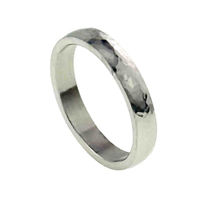 1 of 10: A 4mm hammered stainless steel domed ring is shown at a right facing angle on a white background. The view highlights the reflective hammered surface, smooth flat interior, rounded outer shape, and narrow polished edges.