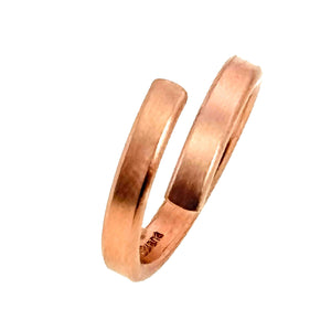 7 of 9: Angled view of the 4mm matte copper bypass ring on a white background, highlighting the thickness and curve of the band.