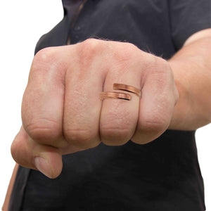 8 of 9: A close-up of a man's fist wearing the 4mm matte copper bypass ring with a black shirt, showcasing the ring's bold yet simple design.
