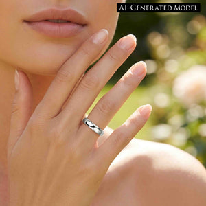 4 of 9: Close view of a woman holding her hand near her face while wearing a polished stainless steel domed ring on her ring finger. Warm outdoor light and a blurred green background frame the silver band. A label reads AI GENERATED MODEL.