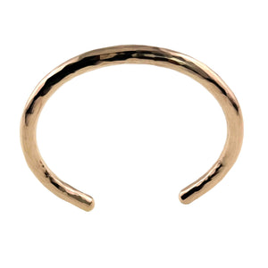 3 of 10: Overhead view of the 5.25mm hammered solid bronze cuff bracelet by John S. Brana against a white background. The image highlights the bracelet's rounded oval shape, smooth interior, open ends, and polished hand hammered exterior. Made from solid bronze containing 92% copper and 8% tin, this sturdy handmade bracelet has a warm golden finish and a rigid structure designed to maintain its shape.