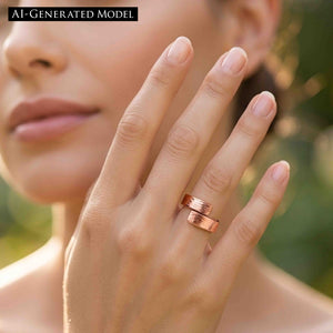 8 of 9: Hand wearing the 5.5mm bark copper bypass ring outdoors near soft greenery, showing the warm copper tone, textured bypass design, and polished shine on a natural feminine styling image.  AI Generated Model.