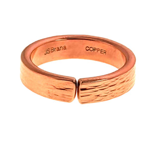 3 of 9: Front view of a handmade 5.5mm copper cuff ring on a white background, featuring an open center gap, hand applied bark texture across the outer band, polished edges, and stamped maker and copper marks inside.